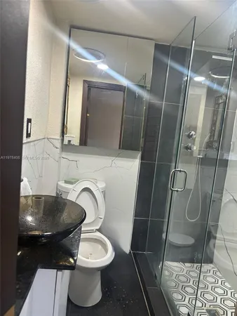 a bathroom with a toilet and a shower