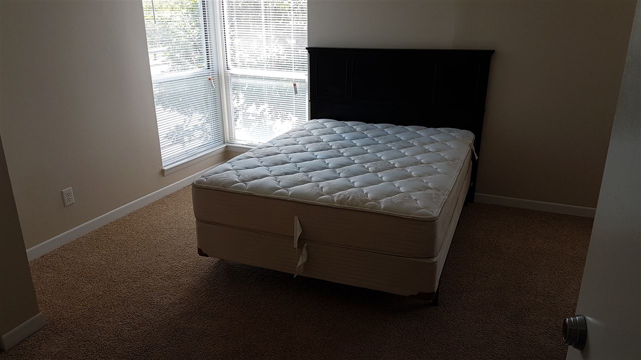 1330 Hunters Road, Unit H Harrisonburg, VA 22801 - Photo 19 of 22 a bed sitting in a bedroom next to a window