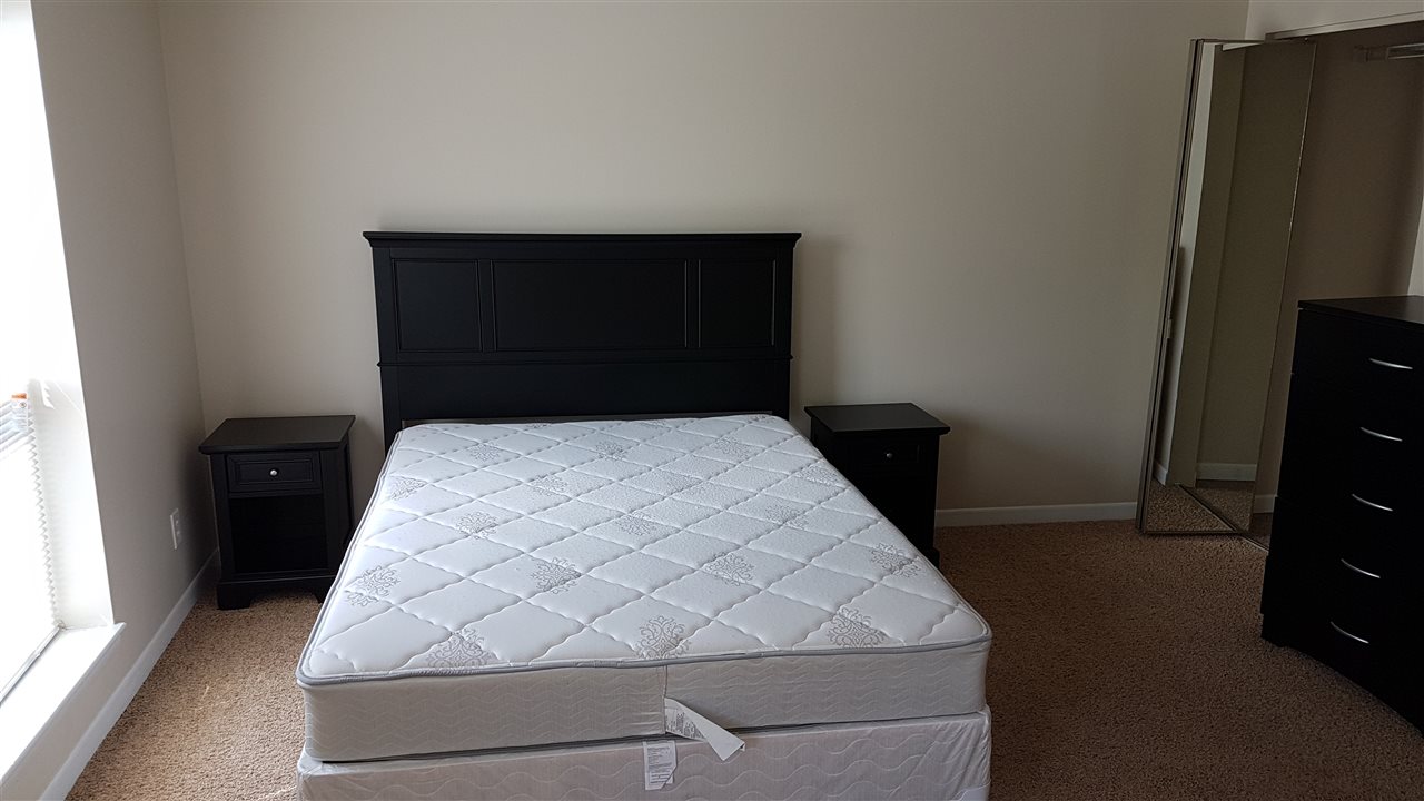 1330 Hunters Road, Unit H Harrisonburg, VA 22801 - Photo 6 of 22 a bedroom with a bed and a night stand