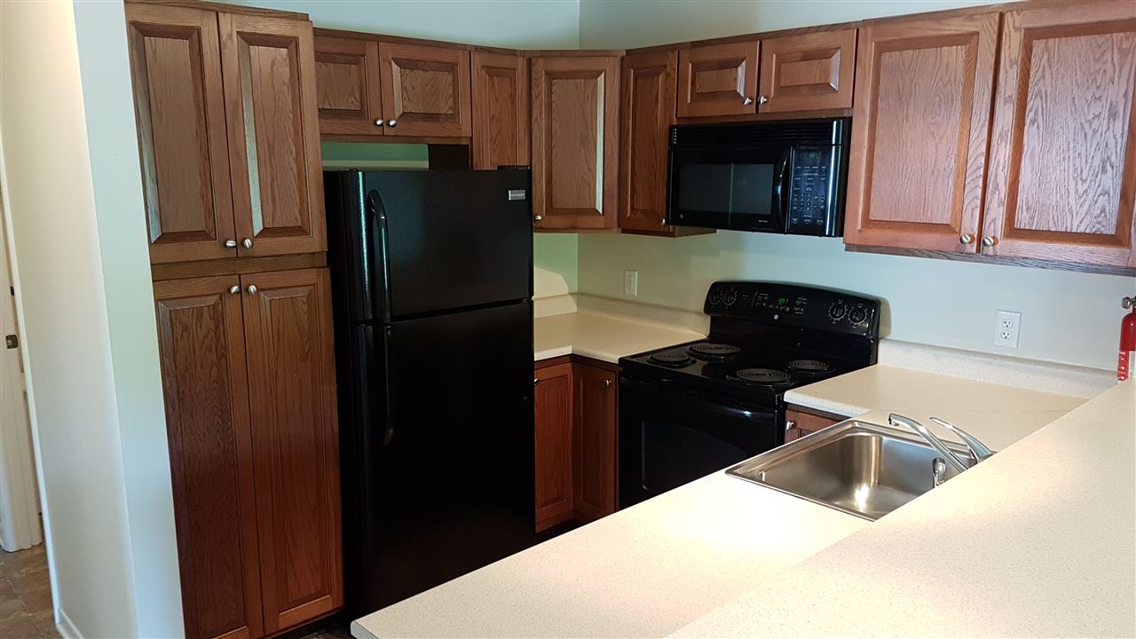 1330 Hunters Road, Unit H Harrisonburg, VA 22801 - Photo 7 of 22 a kitchen with a refrigerator and a stove