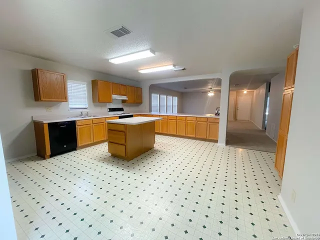 a kitchen with stainless steel appliances a sink a stove a microwave a counter top space
