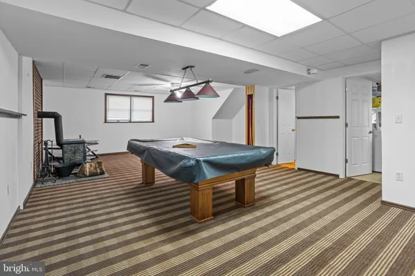 a living room with a table chairs and a wooden floor
