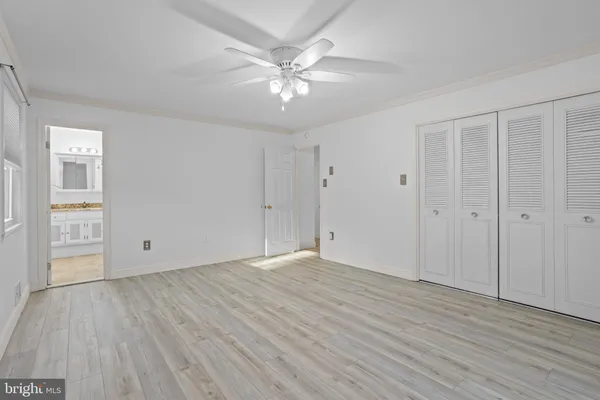 a view of an empty room with wooden floor
