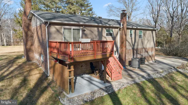 a view of balcony with two chairs and wooden fence