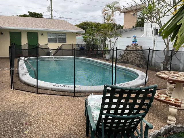 a backyard of a house with table and chairs