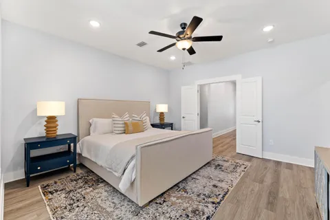 a bedroom with a large bed and a ceiling fan