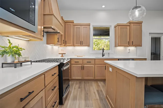 a kitchen with a sink stove and cabinets
