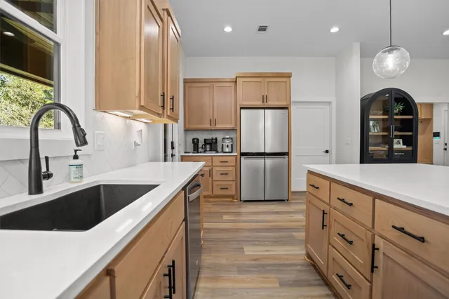 a kitchen with cabinets and stainless steel appliances