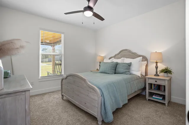 a spacious bedroom with a bed and a cabinets
