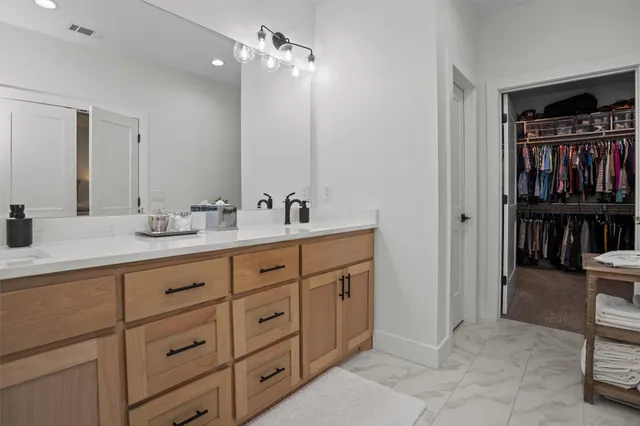 a bathroom with a sink double vanity and a mirror