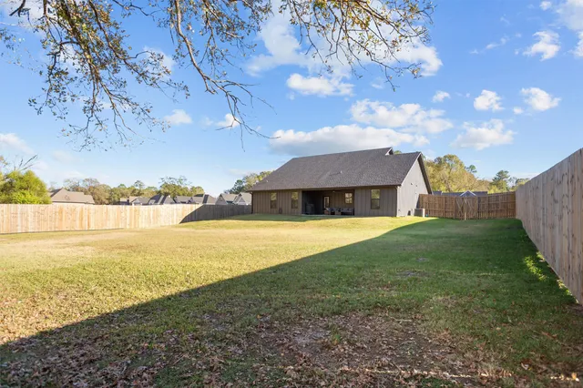 a view of an house with yard and ocean view