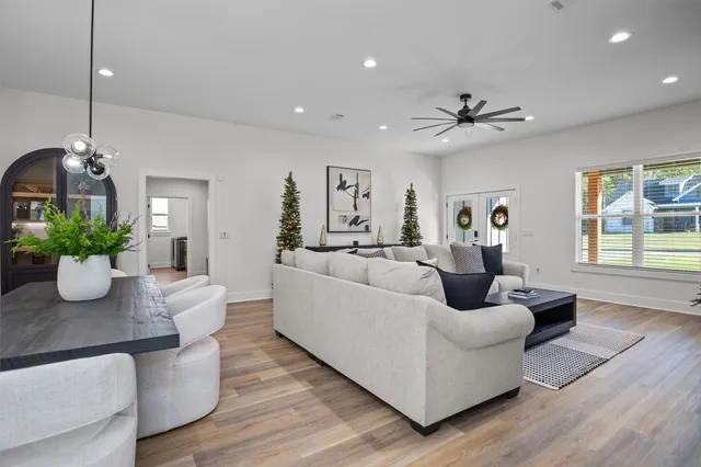 a living room with furniture and a chandelier