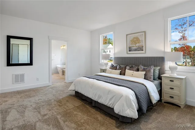 a bathroom with a double vanity sink a mirror and bathtub