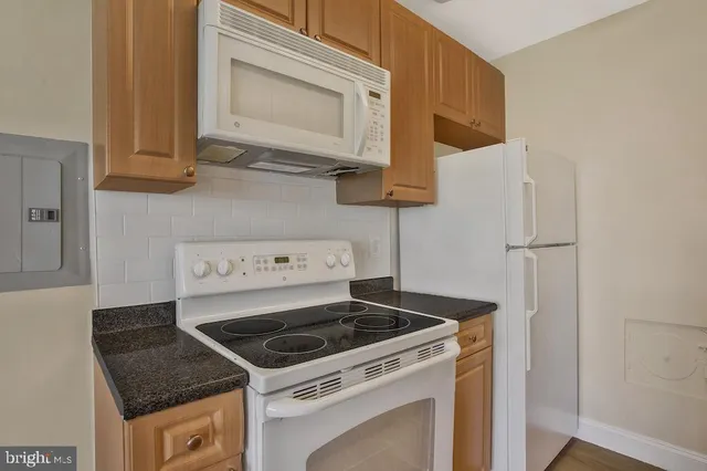 a stove top oven sitting inside of a kitchen
