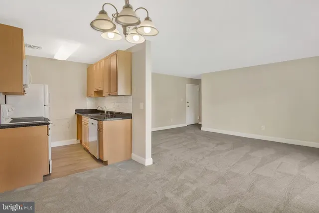 a view of kitchen with cabinets appliances and a ceiling fan