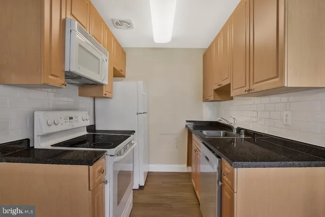 a kitchen that has a sink and a stove