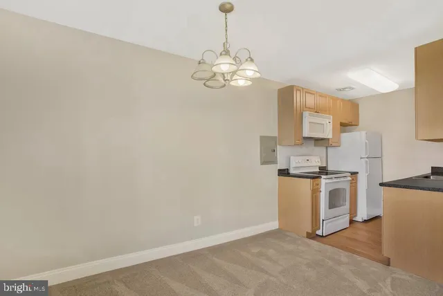 a view of a kitchen with a sink a kitchen and stainless steel appliances