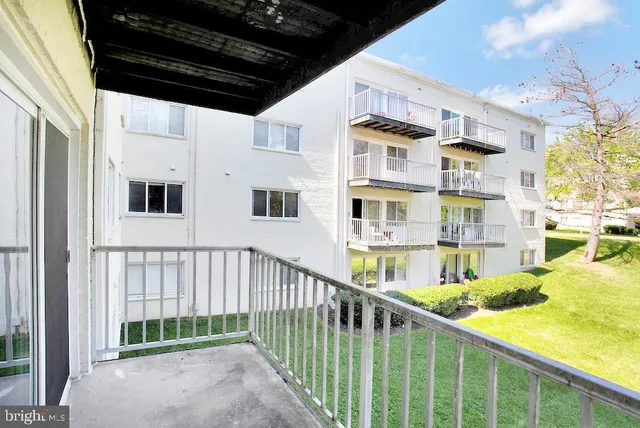 a view of a porch with a floor to ceiling window and stairs