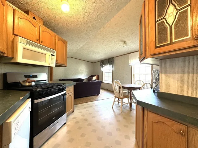 a kitchen with stainless steel appliances granite countertop a stove and a sink