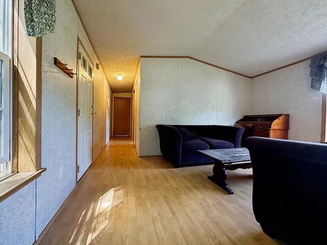 a living room with furniture and a dresser
