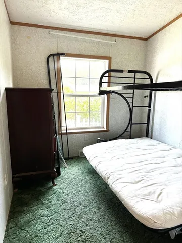 a bedroom with a bed and a mirror