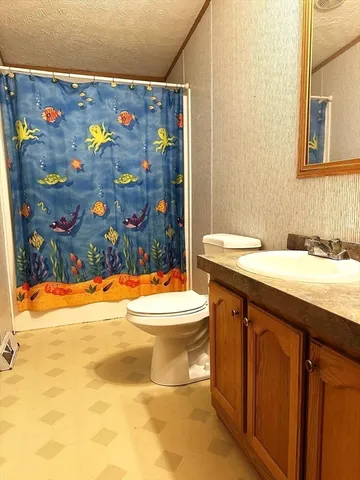 a bathroom with a sink a toilet and bathtub