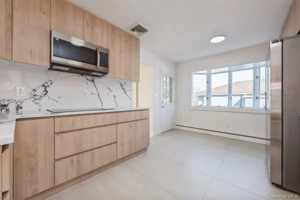 a kitchen with granite countertop cabinets stainless steel appliances and a sink