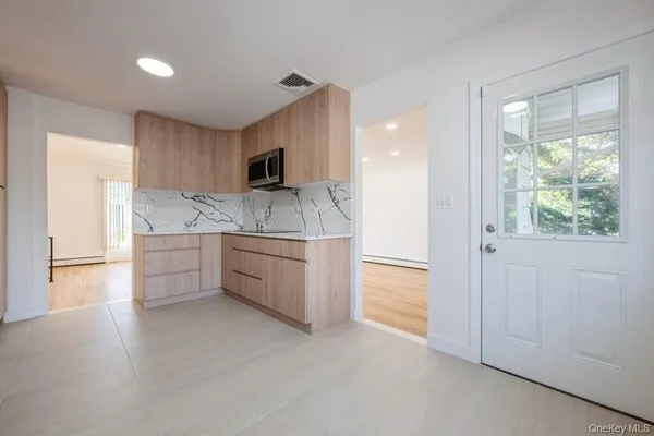 a kitchen with stainless steel appliances granite countertop a sink and a refrigerator