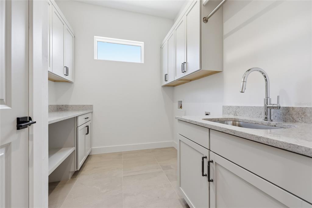 1063 Southwest 135th Way Newberry, FL 32669 - Photo 21 of 42 a kitchen with stainless steel appliances granite countertop white cabinets and a sink