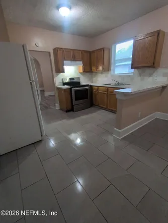 a kitchen with stainless steel appliances granite countertop a sink and a stove