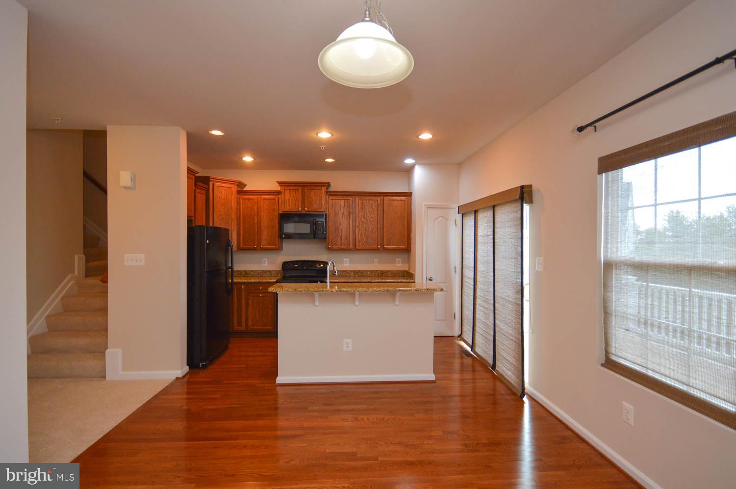 8426 Winding Trail Laurel, MD 20724 - Photo 13 of 41 a view of kitchen with kitchen island wooden floor and refrigerator