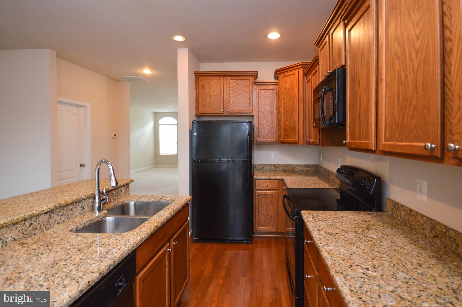8426 Winding Trail Laurel, MD 20724 - Photo 14 of 41 a kitchen with stainless steel appliances granite countertop sink stove refrigerator and cabinets