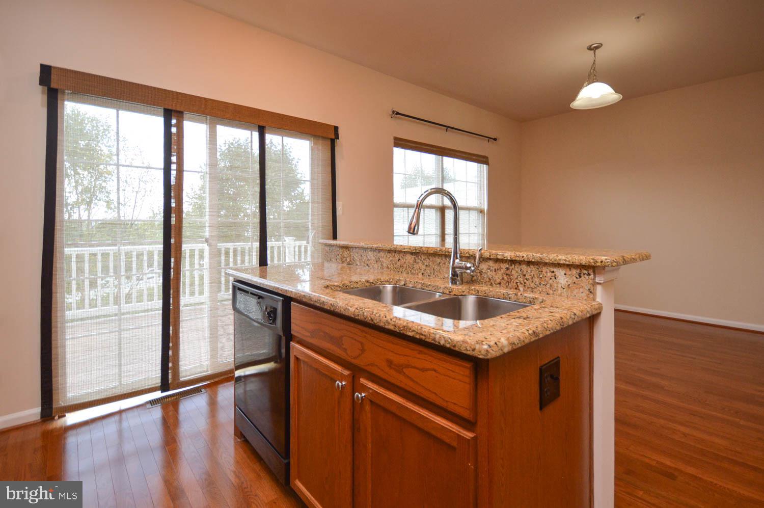 8426 Winding Trail Laurel, MD 20724 - Photo 10 of 41 a kitchen with stainless steel appliances granite countertop a sink and a large window