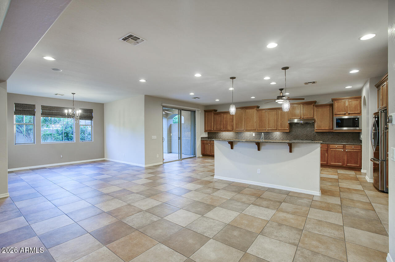 3985 East Hummingbird Lane Phoenix, AZ 85050 - Photo 11 of 47 a view of kitchen with kitchen island granite countertop living room