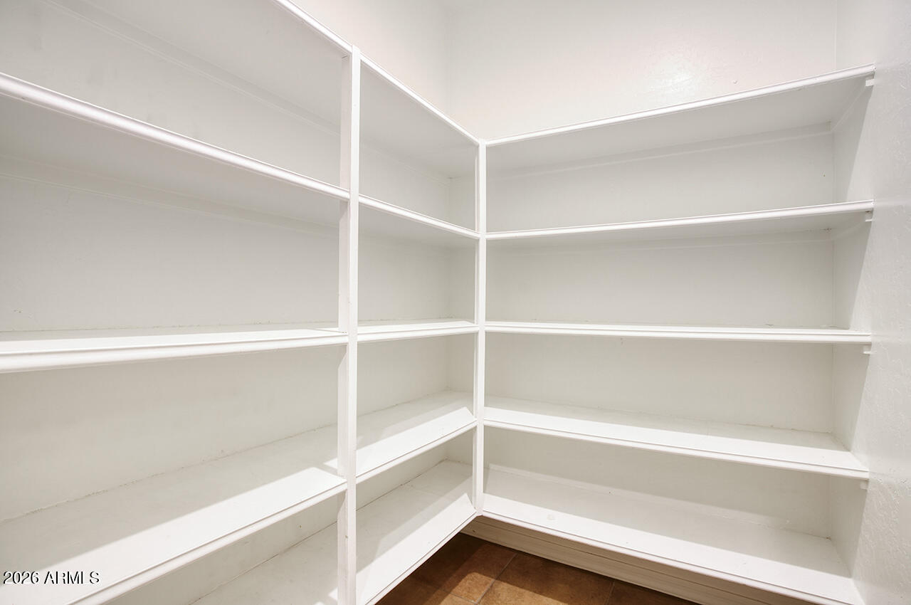3985 East Hummingbird Lane Phoenix, AZ 85050 - Photo 13 of 47 a view of walk in closet with empty racks