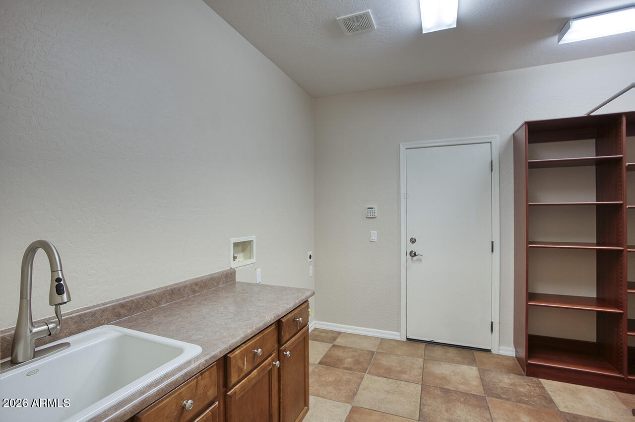 3985 East Hummingbird Lane Phoenix, AZ 85050 - Photo 14 of 47 a kitchen with a sink cabinets and appliances