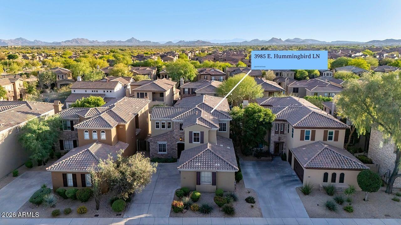 3985 East Hummingbird Lane Phoenix, AZ 85050 - Photo 2 of 47 an aerial view of multiple houses with a lake view