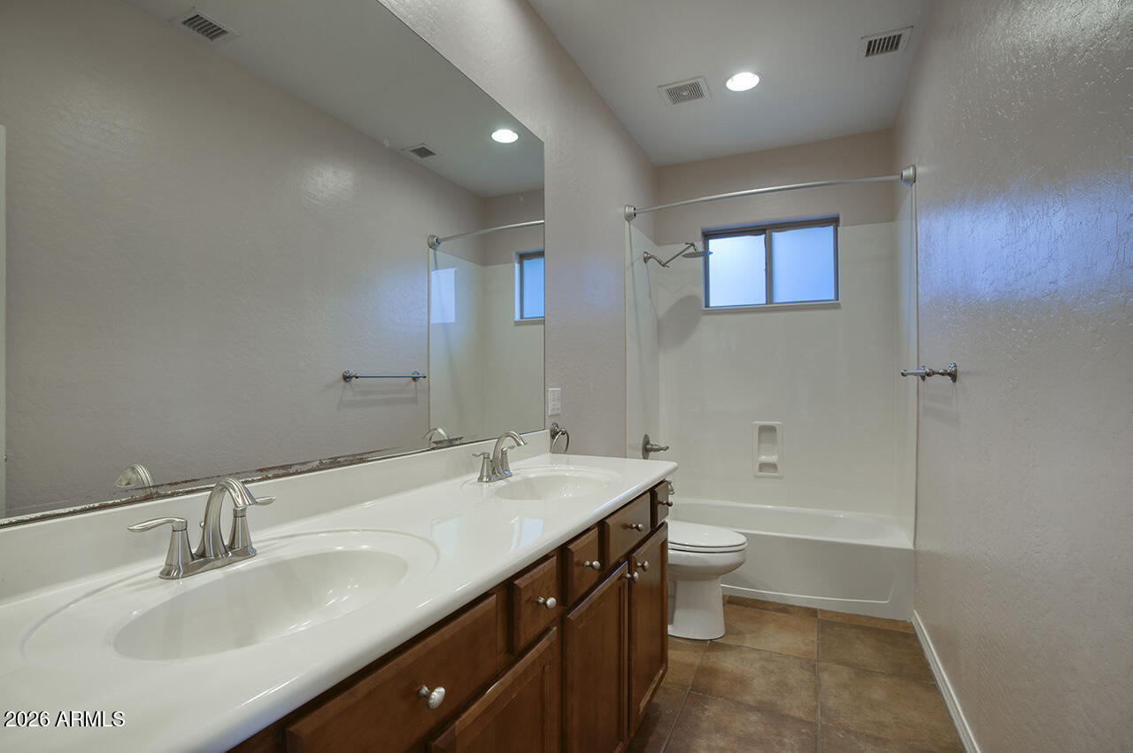 3985 East Hummingbird Lane Phoenix, AZ 85050 - Photo 23 of 47 a bathroom with a sink a toilet and shower
