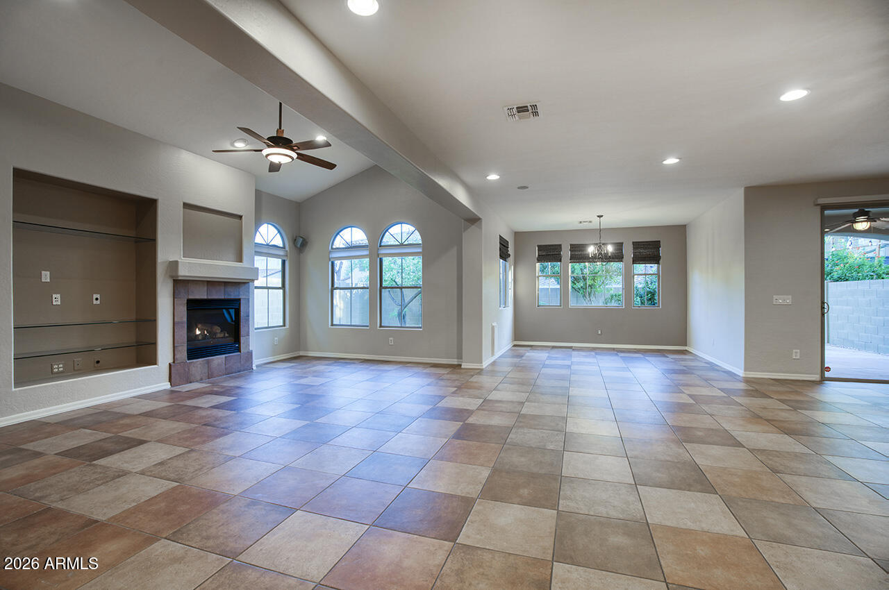 3985 East Hummingbird Lane Phoenix, AZ 85050 - Photo 5 of 47 a view of an empty room with a fireplace and a window