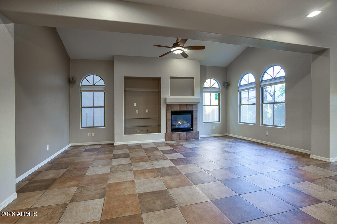 3985 East Hummingbird Lane Phoenix, AZ 85050 - Photo 6 of 47 a view of empty room with a fireplace and fan