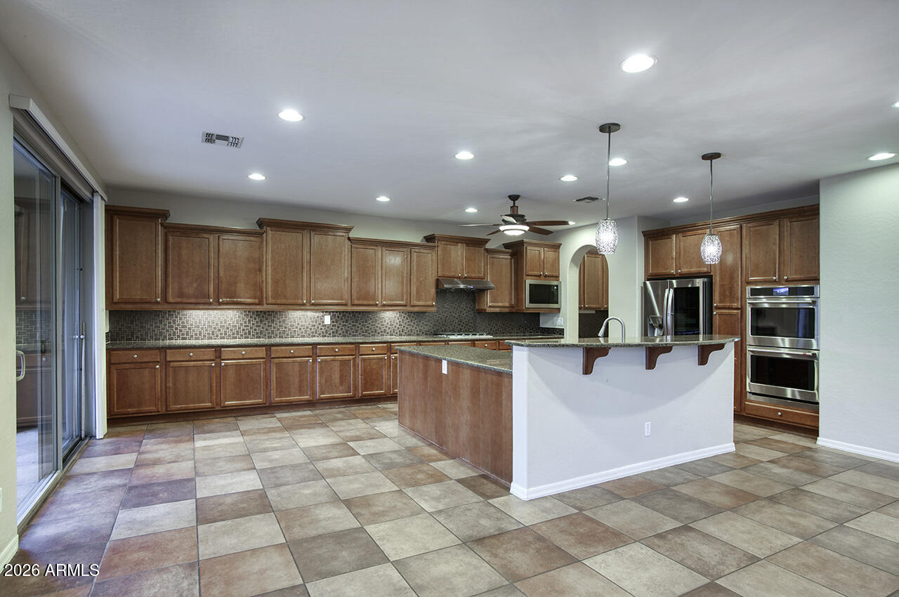 3985 East Hummingbird Lane Phoenix, AZ 85050 - Photo 10 of 47 a large kitchen with stainless steel appliances lots of counter top space