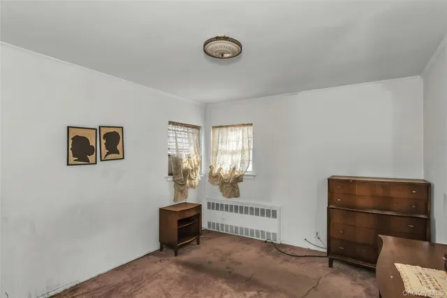 a living room with furniture a chandelier and a window