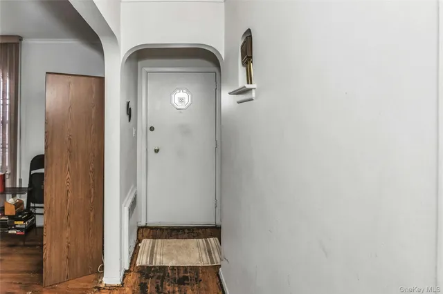 a living room with furniture a dining table and wooden floor