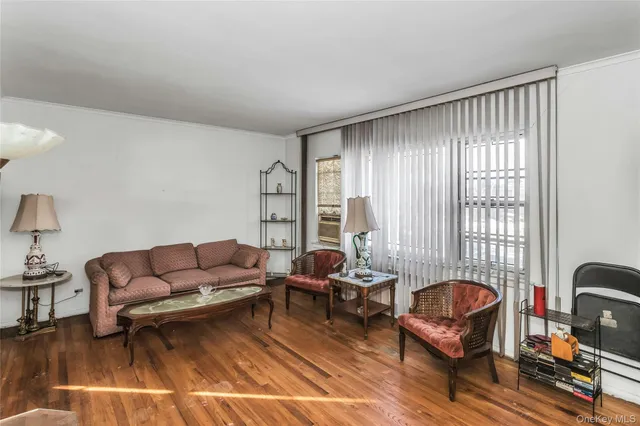 a dining room with furniture a chandelier and wooden floor