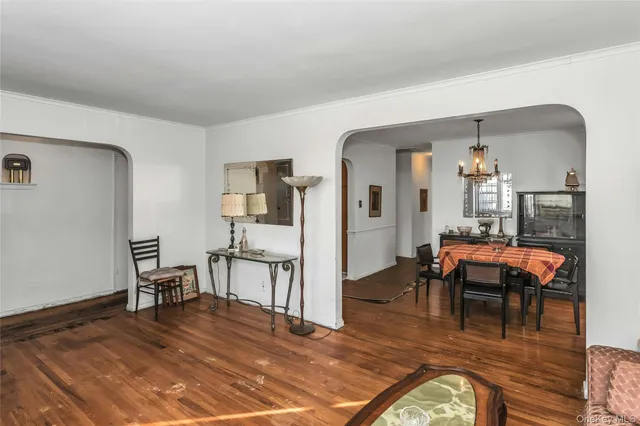 a bedroom with a bed and dresser with mirror