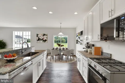 a kitchen with stove and cabinets