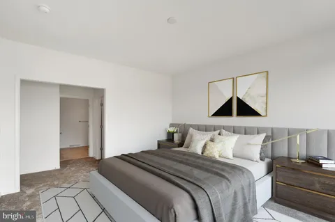 a bedroom with a bed and painting on the wall