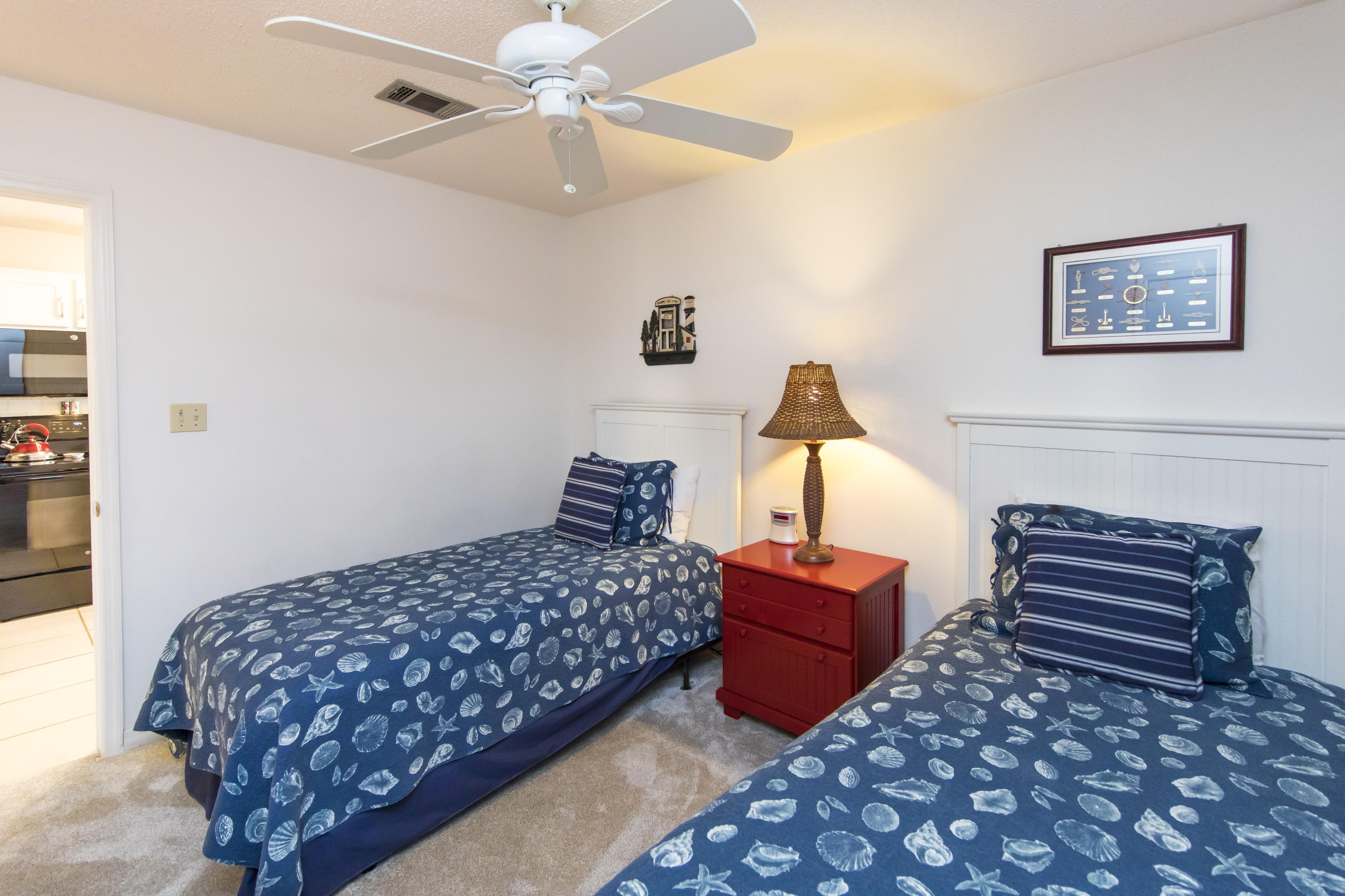 3799 Cty Highway, Unit H10 Santa Rosa Beach, FL 32459 - Photo 16 of 21 a bedroom with a bed and a chandelier