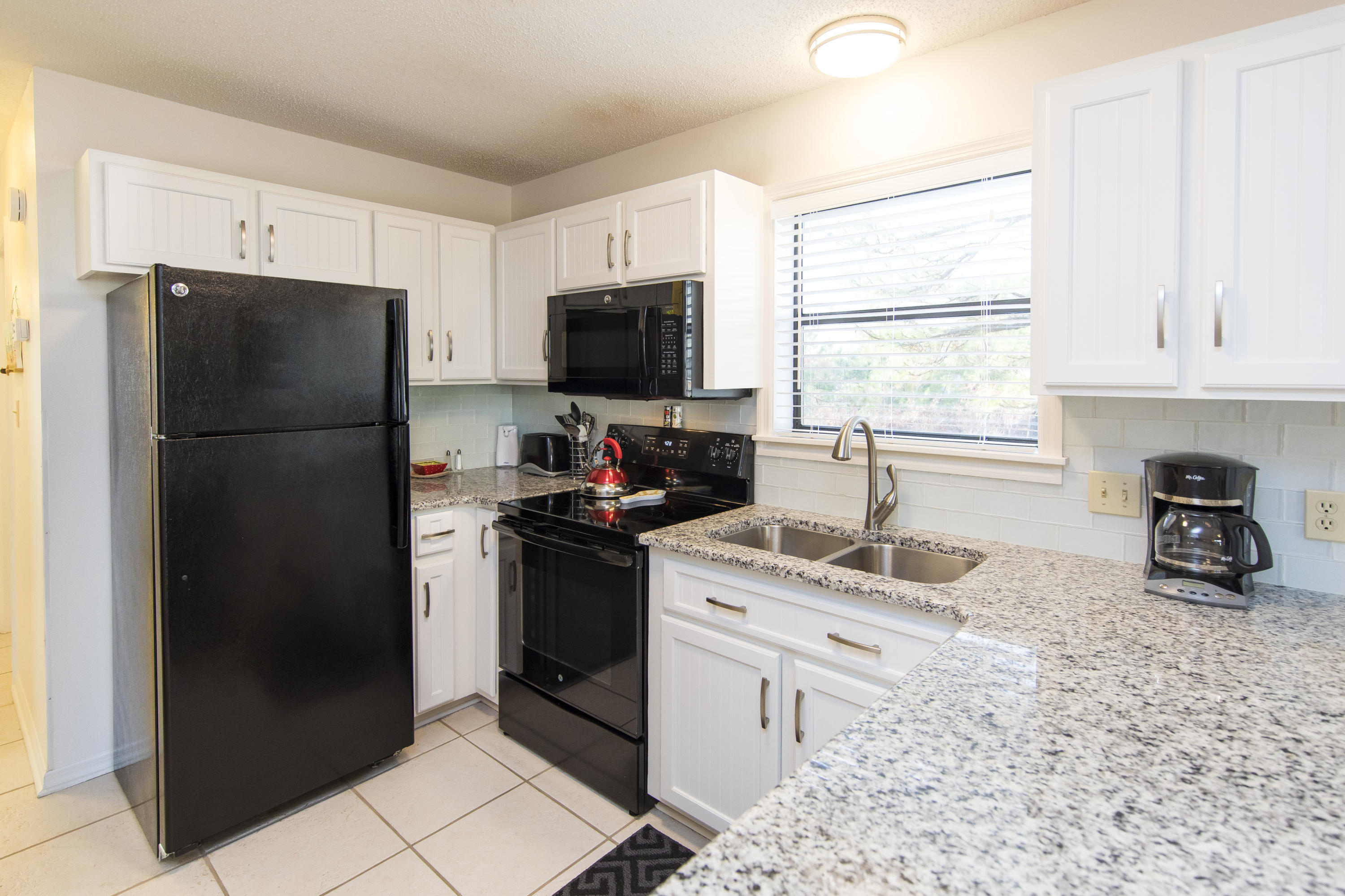 3799 Cty Highway, Unit H10 Santa Rosa Beach, FL 32459 - Photo 2 of 21 a kitchen with a refrigerator stove and sink