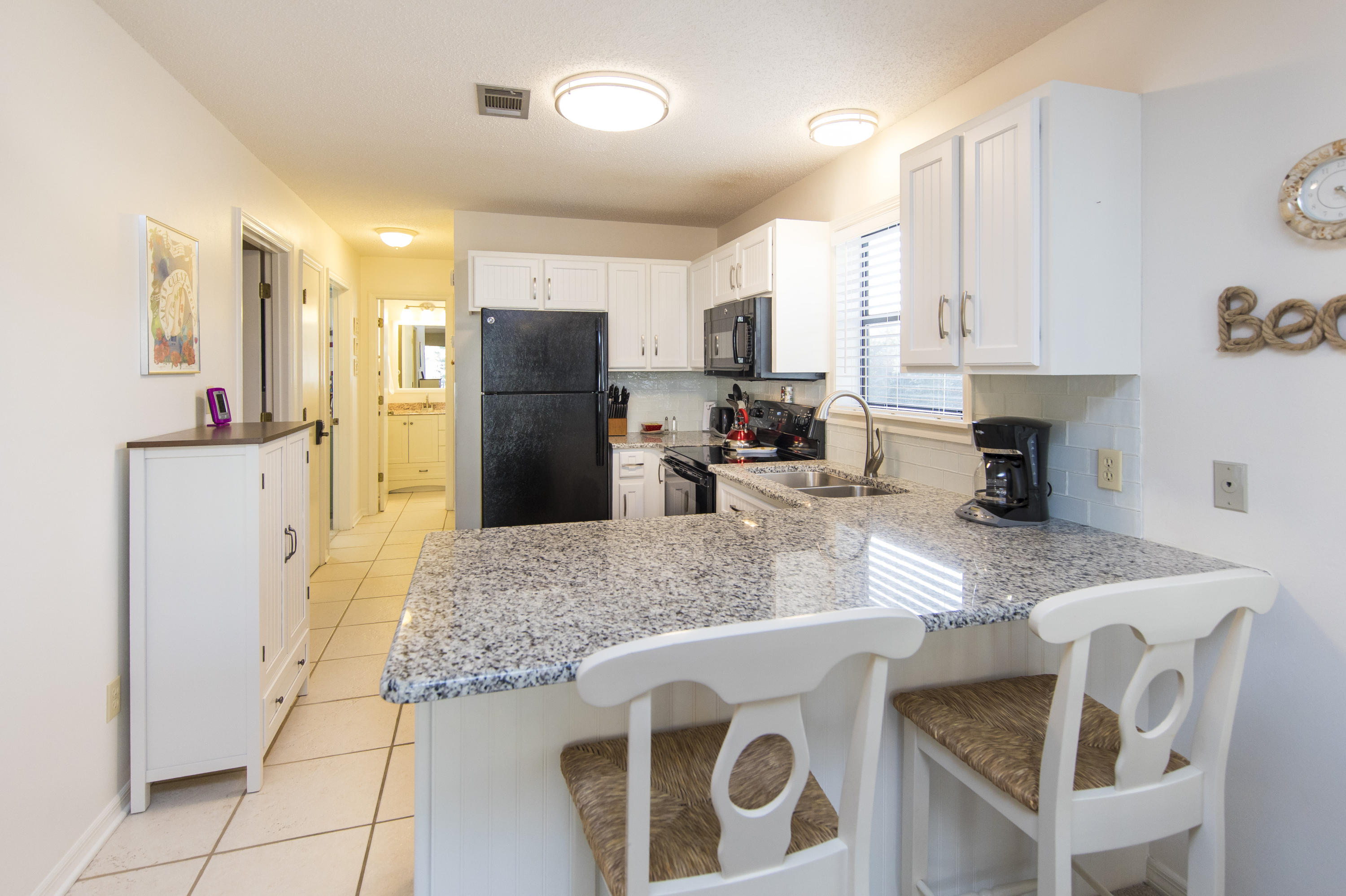 3799 Cty Highway, Unit H10 Santa Rosa Beach, FL 32459 - Photo 3 of 21 a kitchen with stainless steel appliances granite countertop a sink a stove a refrigerator a counter top space and cabinets